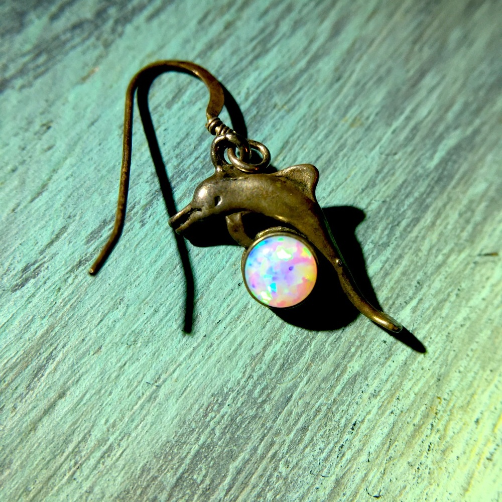 Silver dolphin and white opal earring